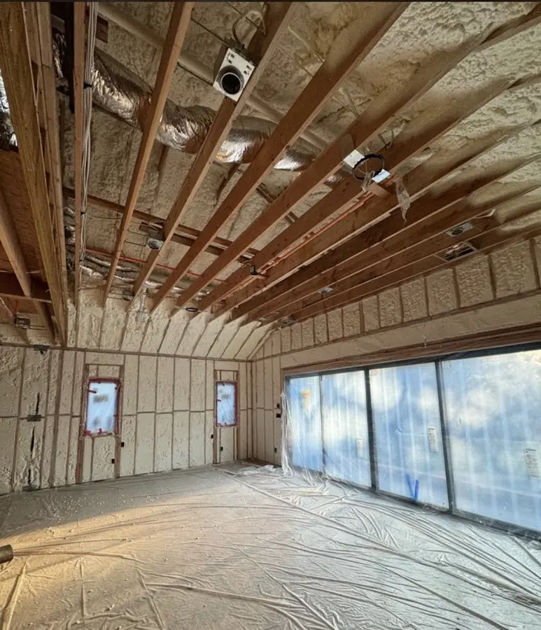 Interior walls and ceiling insulated with spray foam during new construction in Larchmont